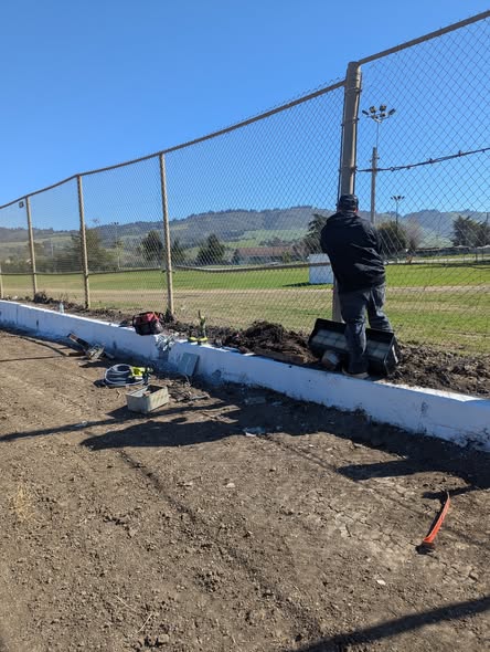 Electrician performing fence line electrical work